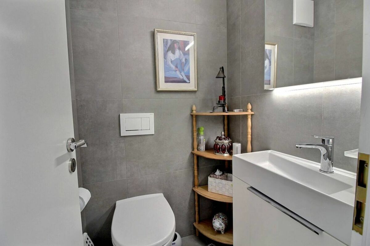 Modernes Gäste-WC mit Waschbecken und Wandregal