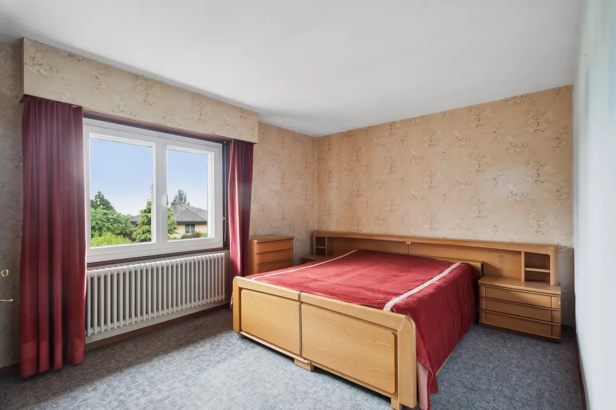 Schlafzimmer mit Doppelbett und Fenster