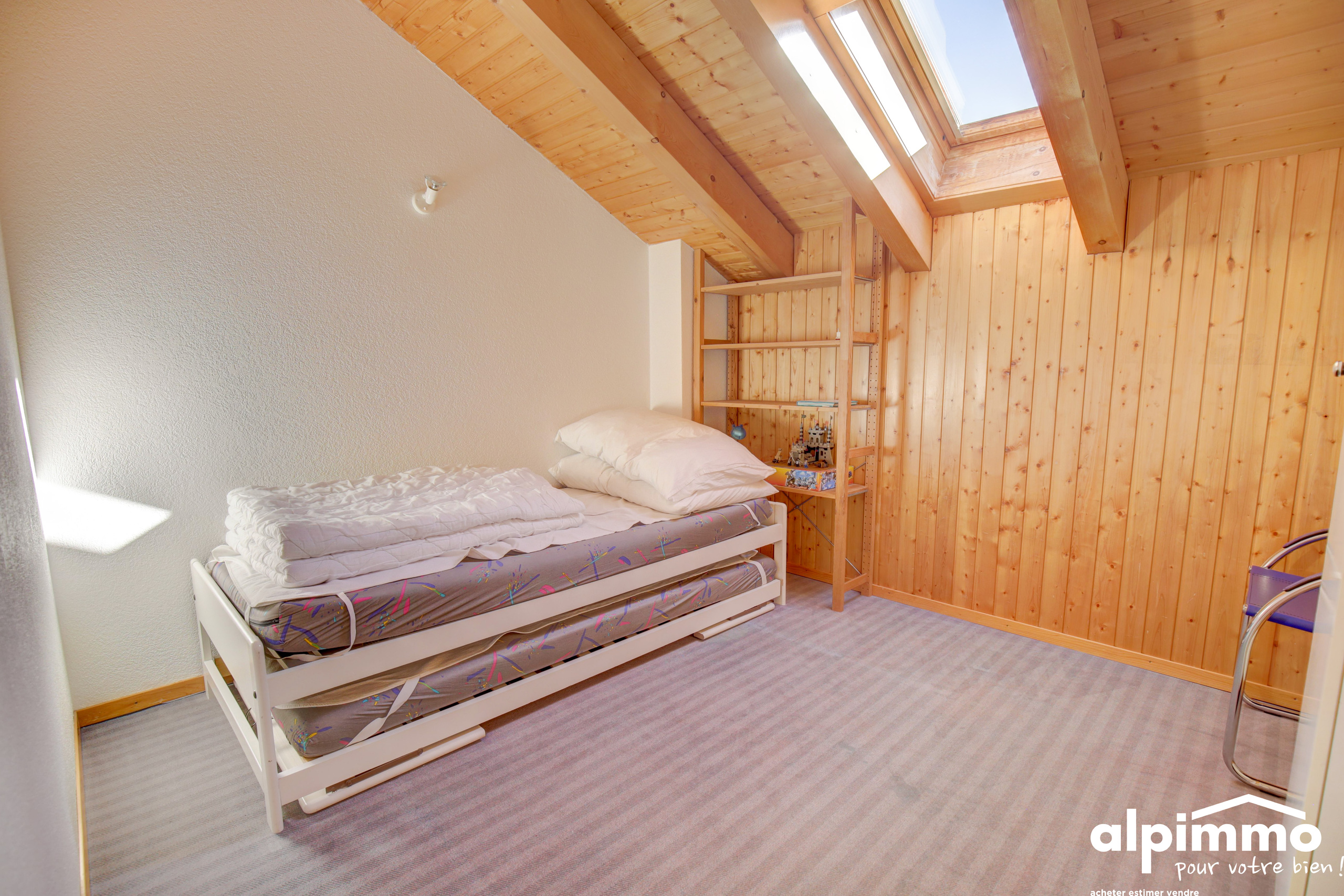 Dachzimmer mit Einzelbett und Dachfenster