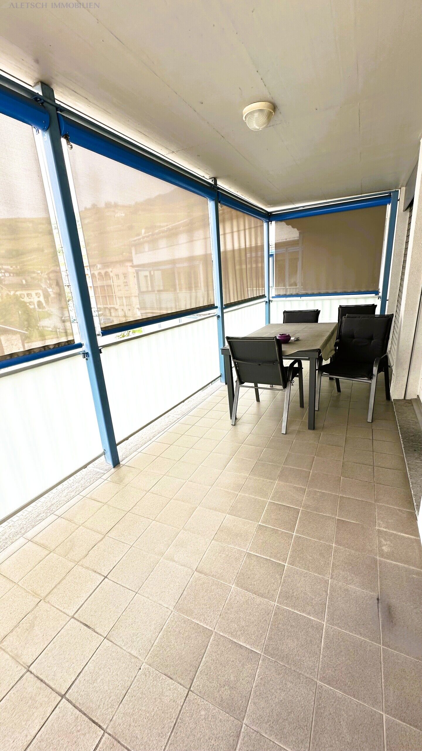 Überdachter Balkon mit Sitzgruppe