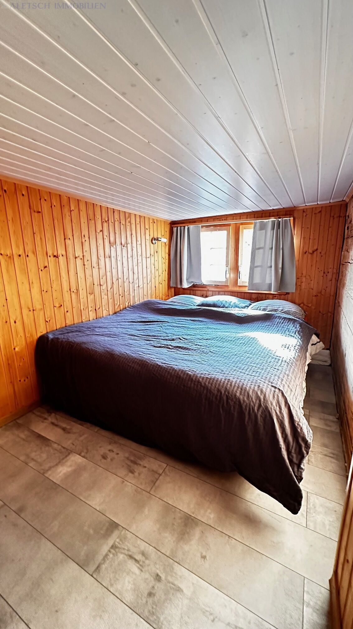 Schmales Schlafzimmer mit Holzvertäfelung