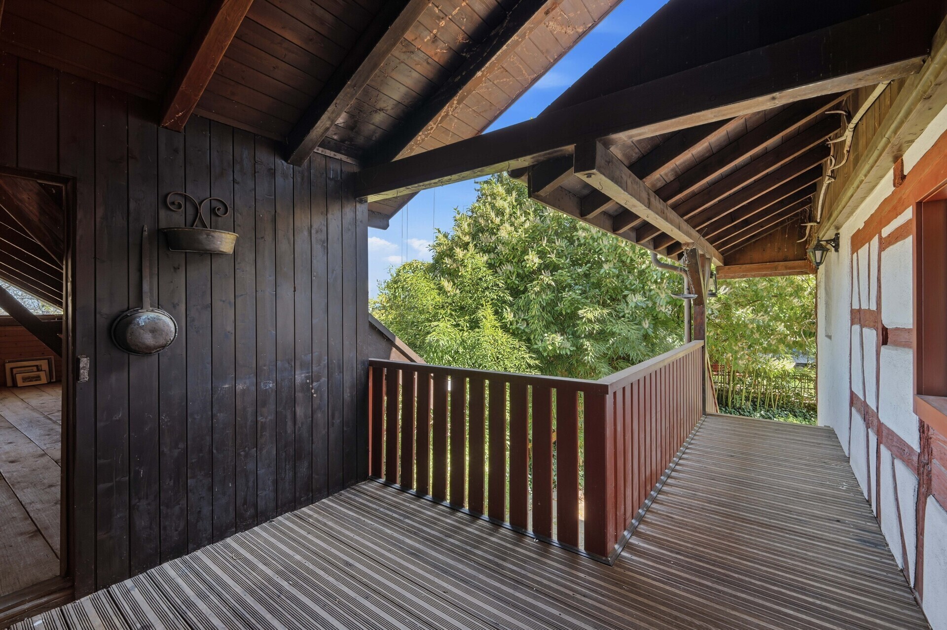 Überdachter Balkon mit Blick ins Grüne