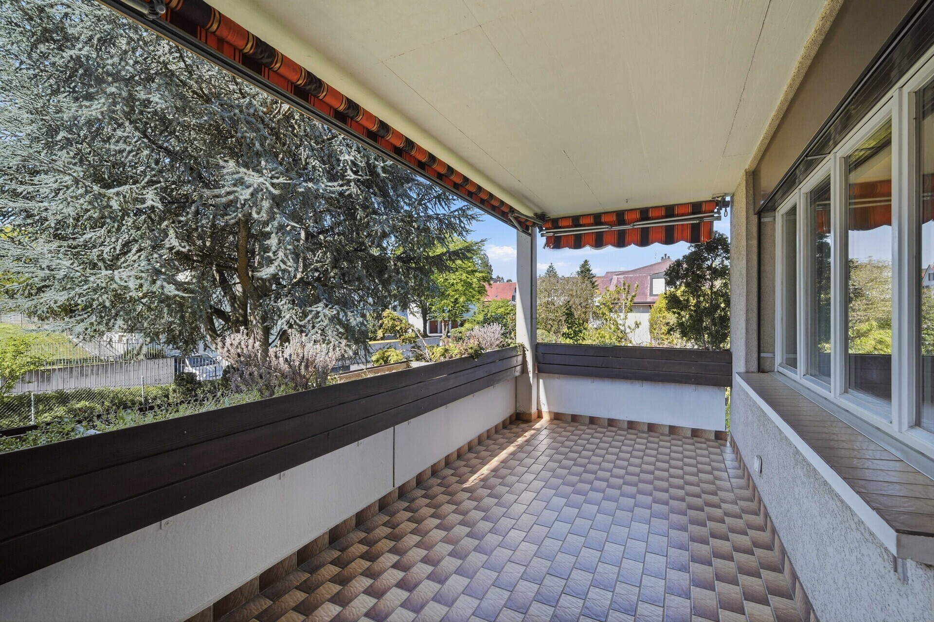 Überdachter Balkon mit Blick ins Grüne