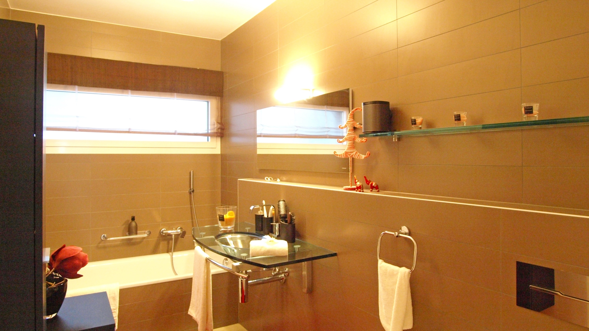 Modernes Badezimmer mit Wanne und Glaswaschtisch