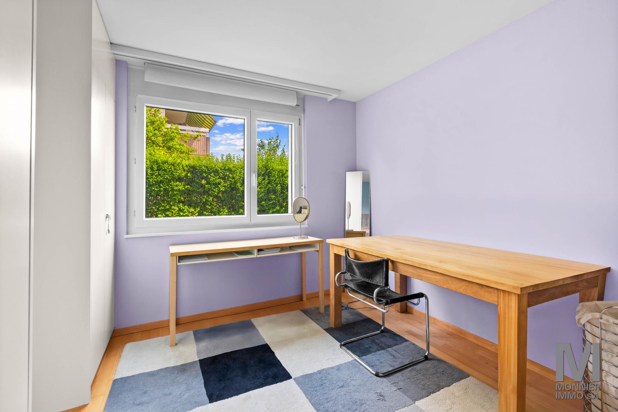 Lila Arbeitszimmer mit Fenster und Schreibtisch