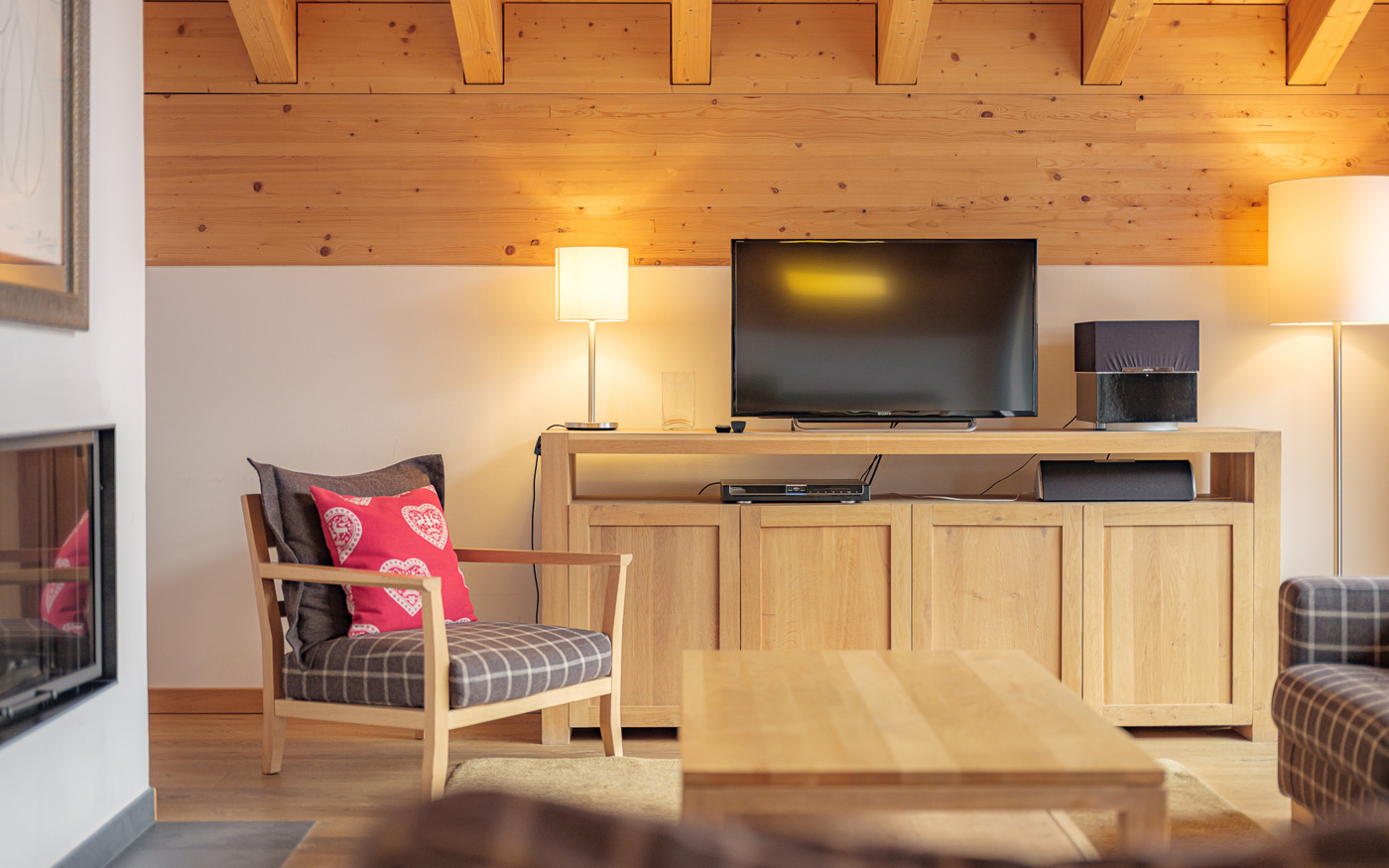 Wohnzimmer mit Kamin und Holzverkleidung