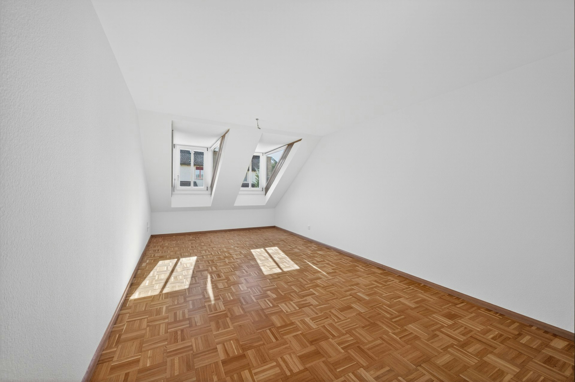 Leerer Dachzimmerraum mit Dachfenstern
