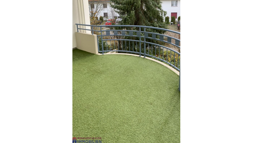 Balkon mit grünem Bodenbelag und Rundgeländer