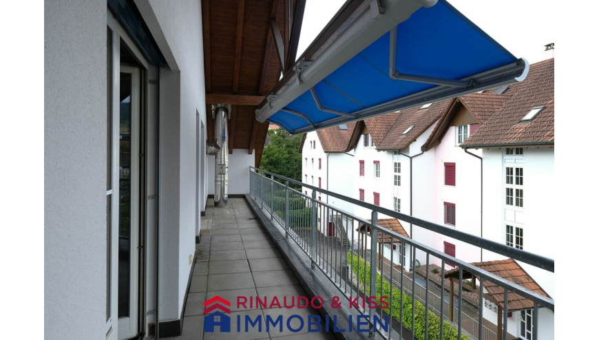 Überdachter Balkon mit Blick auf gegenüberliegende Wohnhäuser