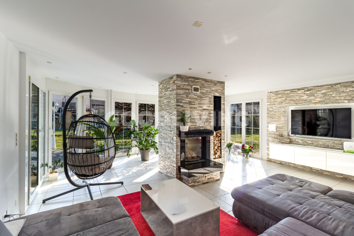 Heller Wohnraum mit Kamin und TV-Wand
