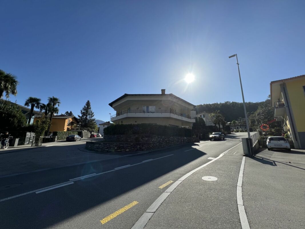 Wohnstraße mit freistehendem Wohnhaus unter klarem Himmel