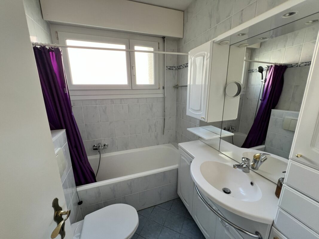 Helles Badezimmer mit Badewanne und Waschtisch