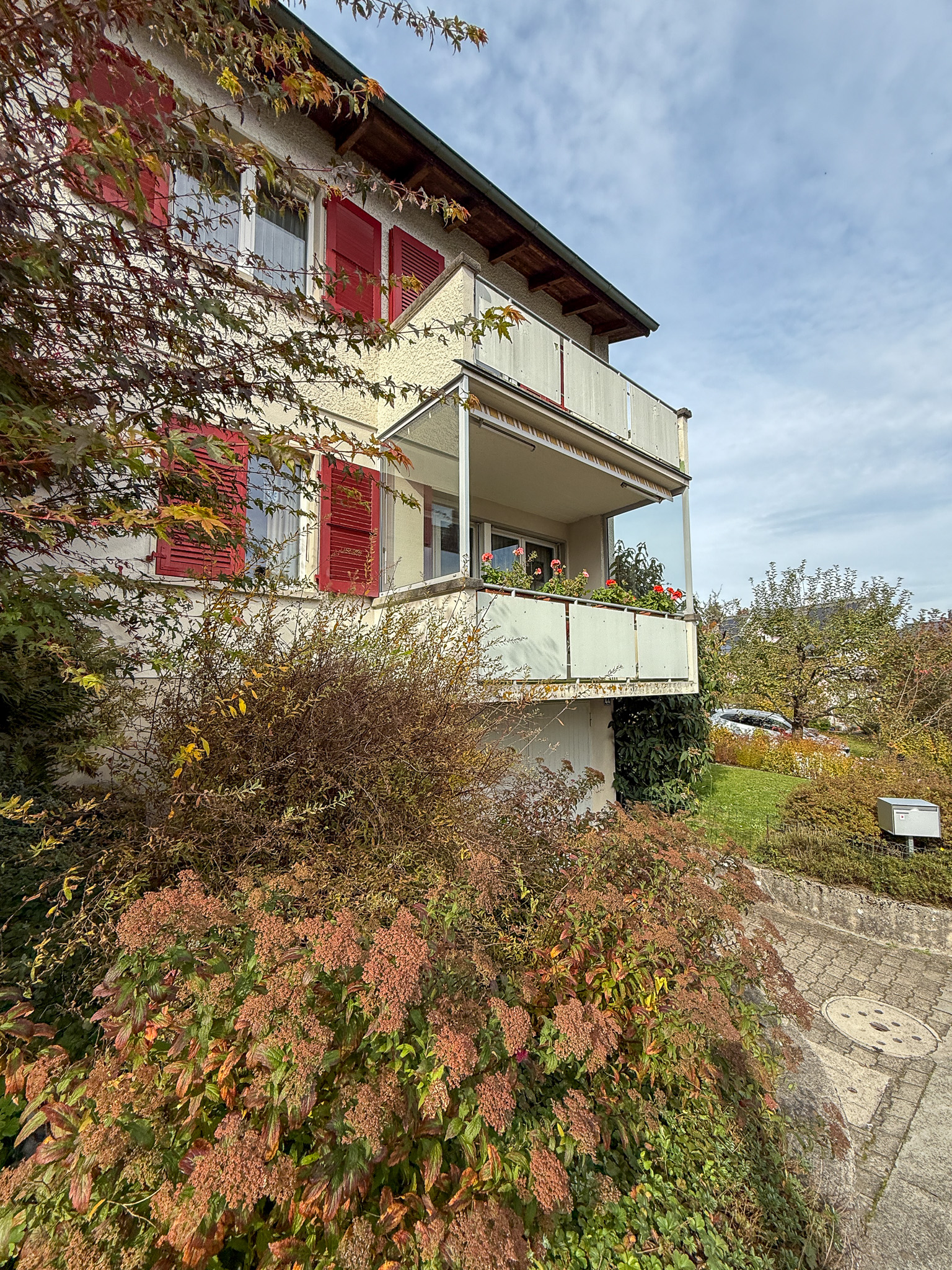 Mehrfamilienhaus mit Balkon und Gartenansicht
