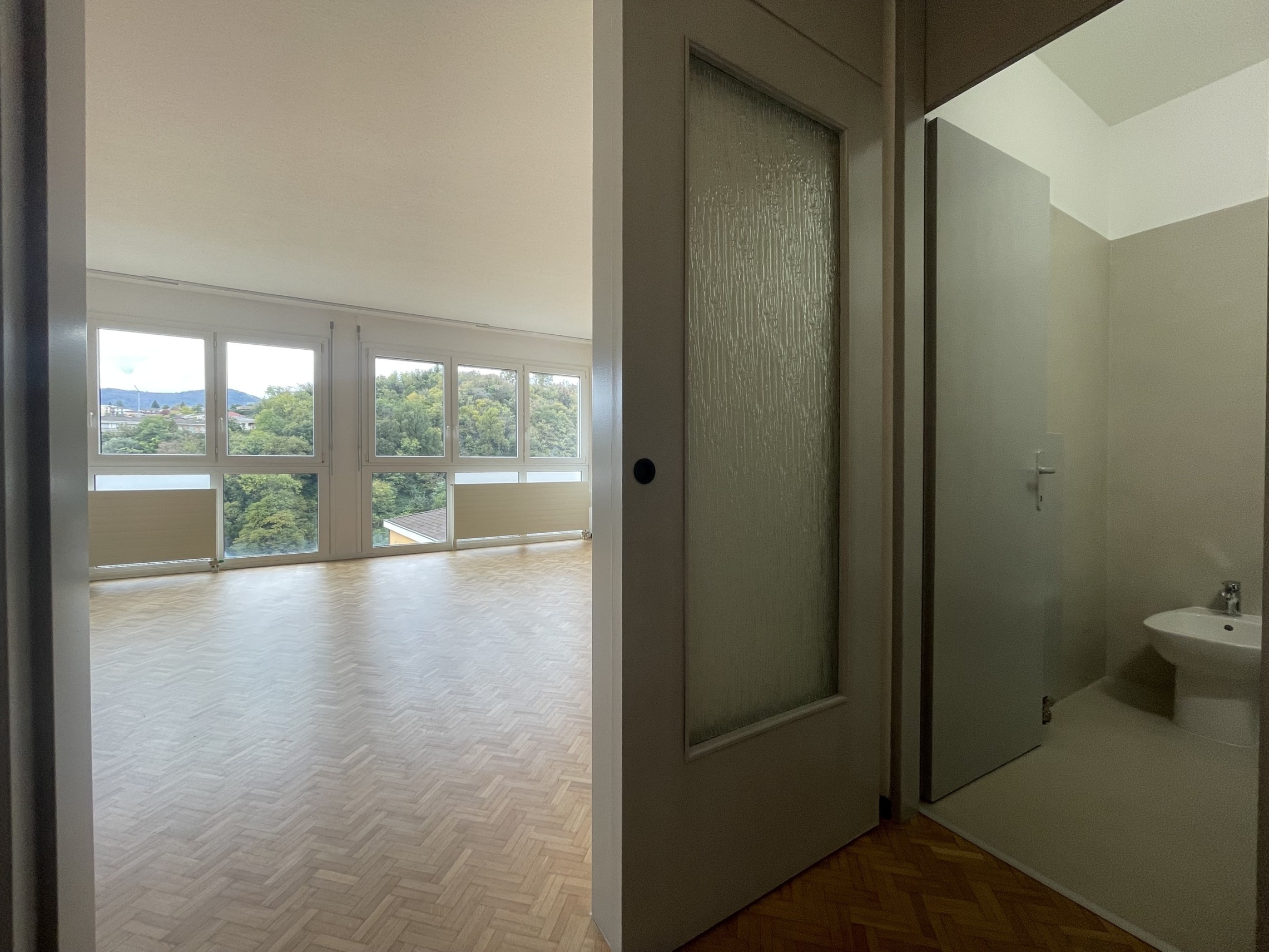 Lichtdurchflutete Wohnung mit großem Fenster und angrenzendem Bad