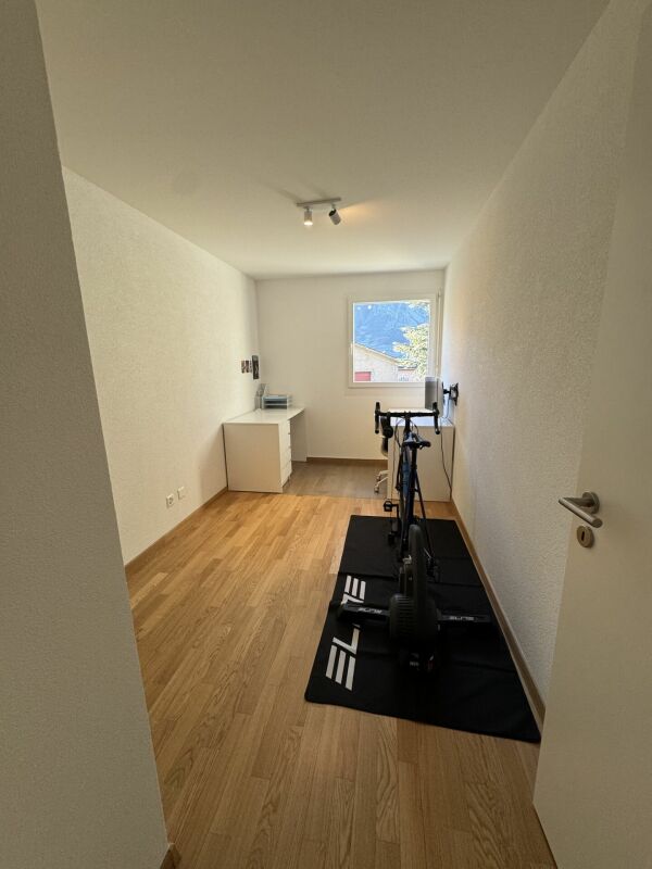 Schmaler Fitnessraum mit Fahrradtrainer
