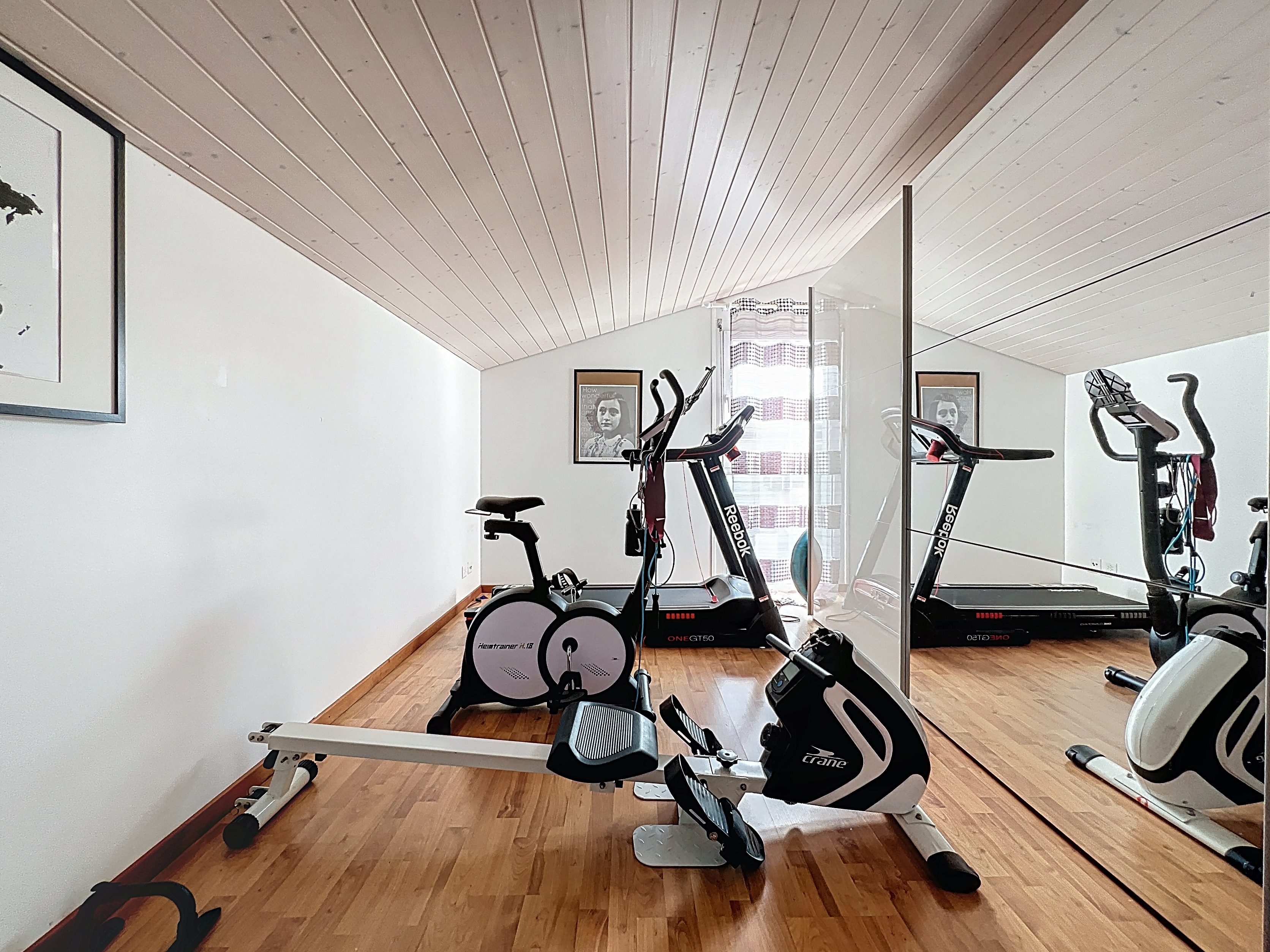 Fitnessraum mit Heimtrainern und Spiegelwand