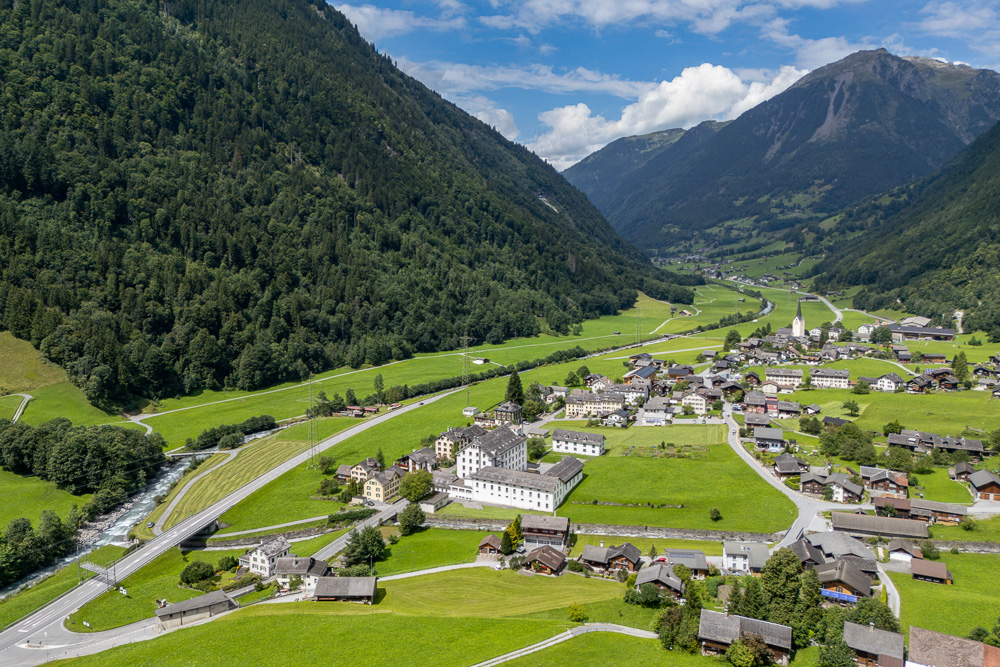 Luftaufnahme eines Alpentals mit Dorf