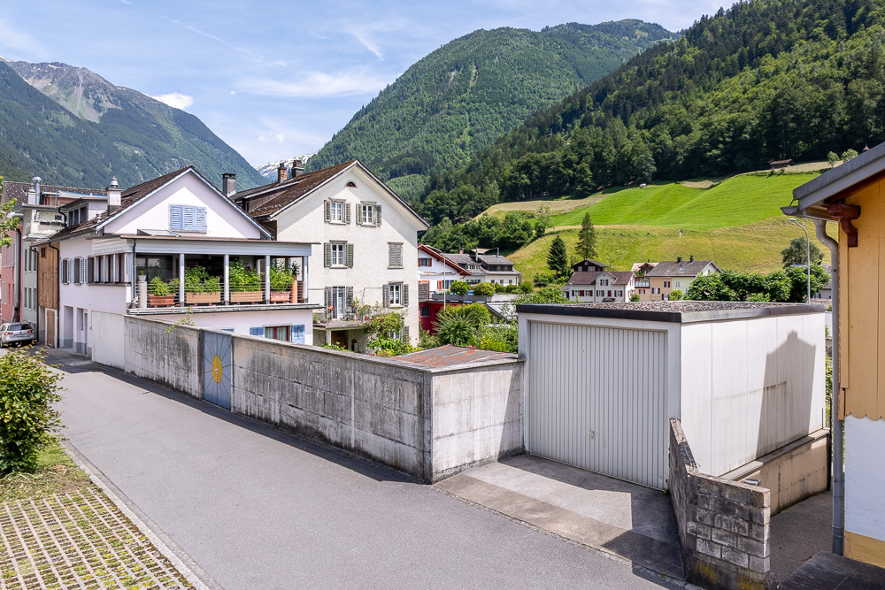 Alpiner Ortsblick mit Wohnhäusern und Bergen