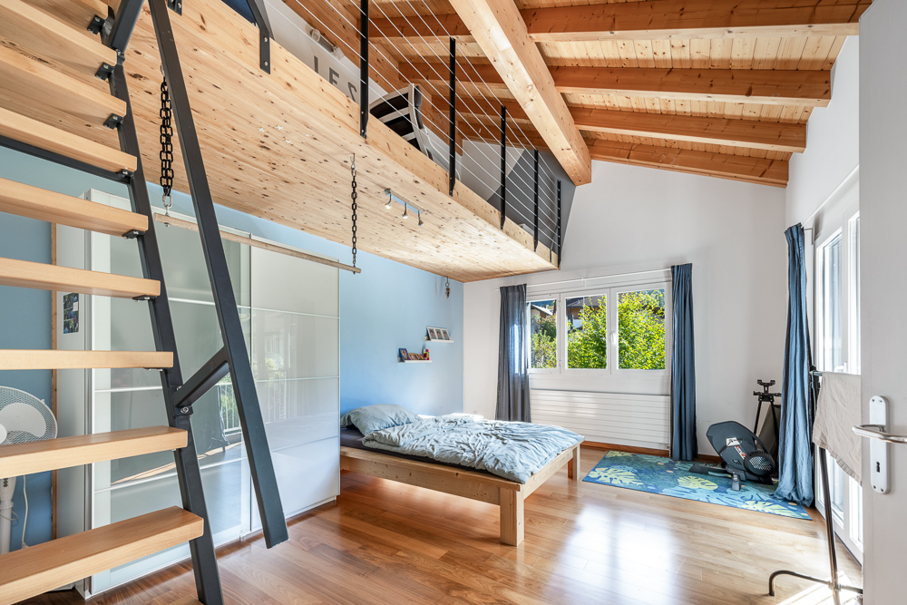Helles Schlafzimmer mit Galerie und Holzdach