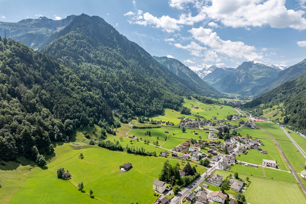 Alpenlandschaft mit Talort und Bergen