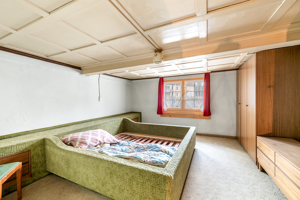 Schlafzimmer mit Einbaumöbeln und stark gemusterter Decke