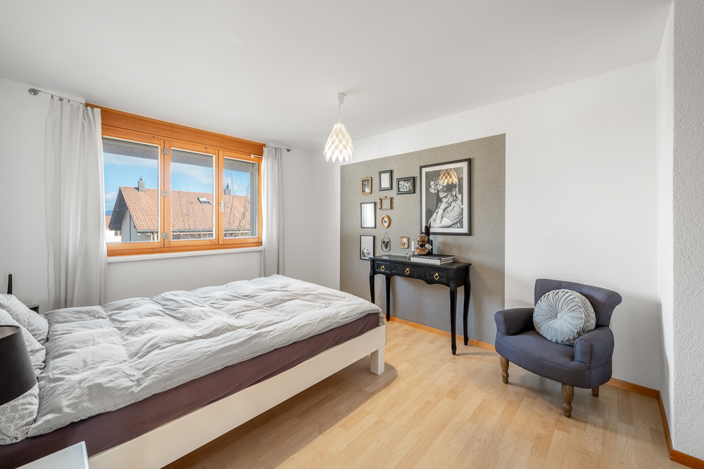 Helles Schlafzimmer mit Blick auf Nachbarhäuser