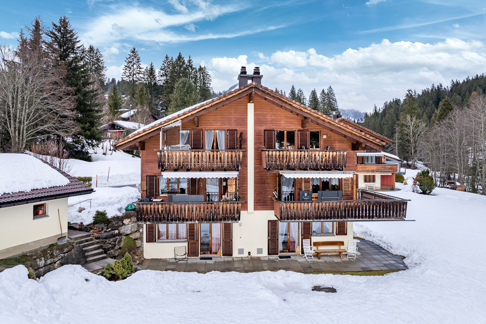 Schneebedecktes Chalet mit Balkonen