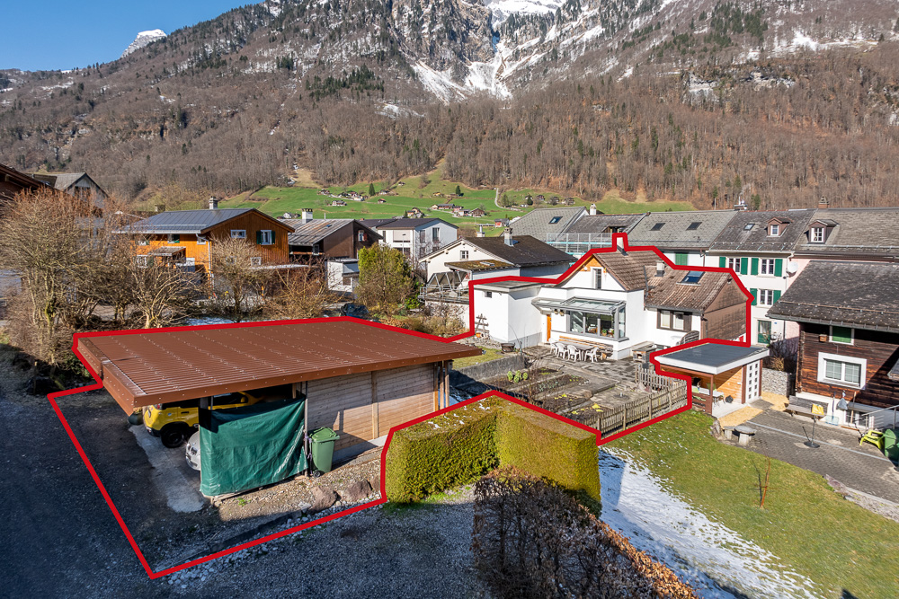 Außenansicht eines alpinen Wohnhauses mit Nebengebäuden