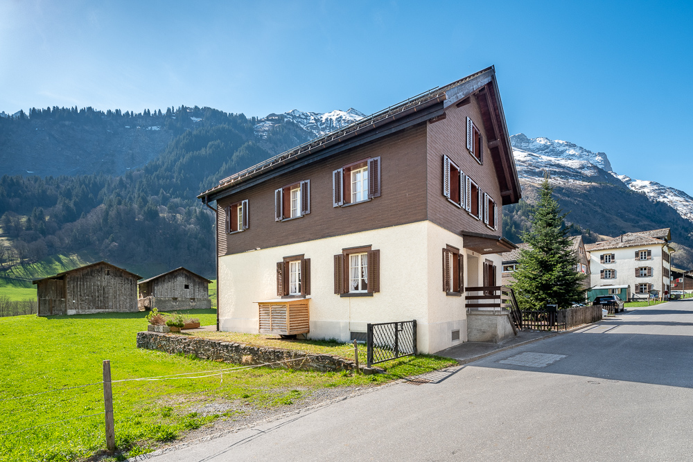 Alpines Wohnhaus am Hang mit Bergkulisse