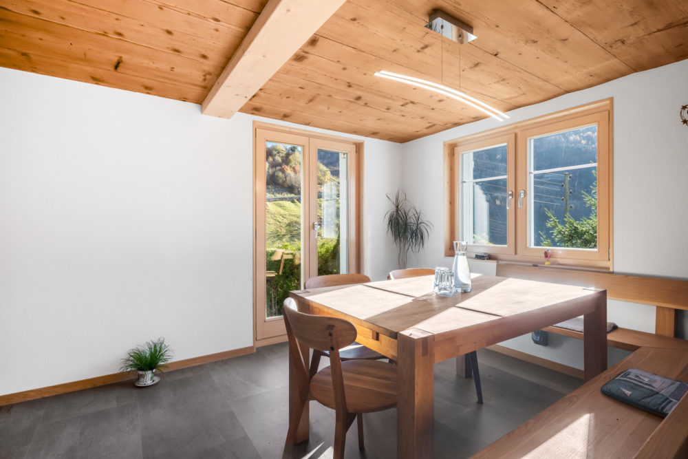 Essbereich mit Holzboden und großen Fenstern
