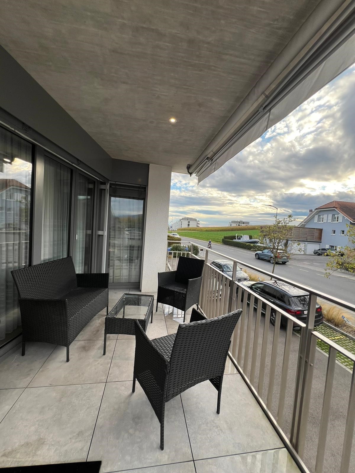 Balkon mit Sitzgruppe und Straßenblick