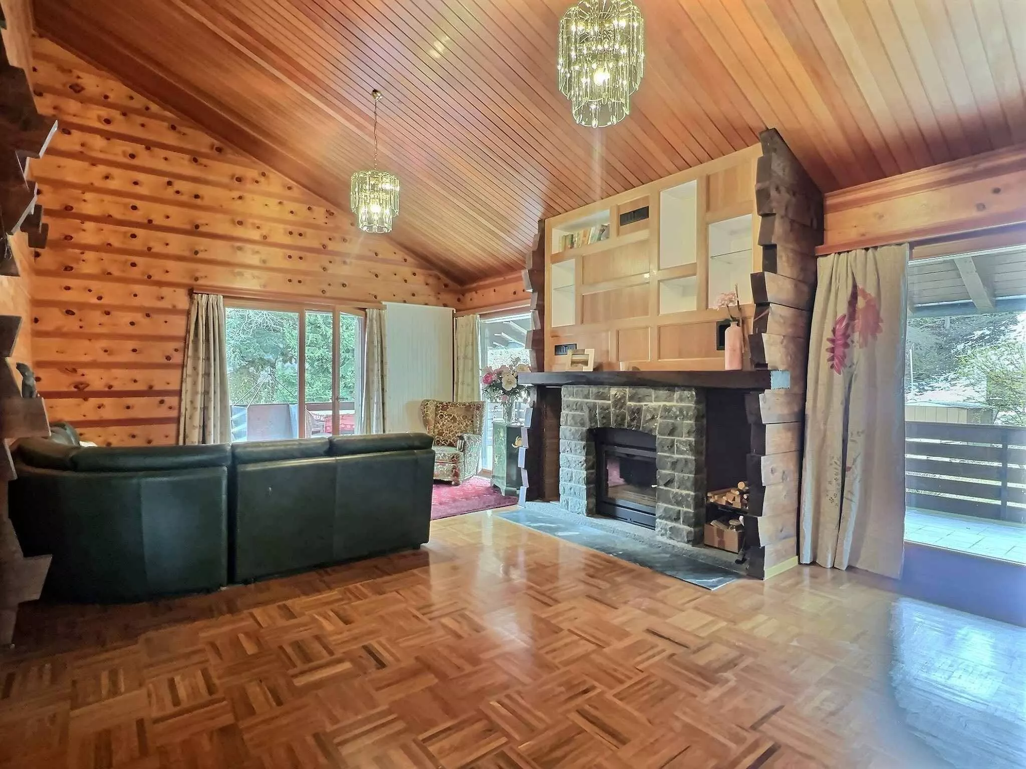 Gemütliches Wohnzimmer mit Holzverkleidung und Kamin