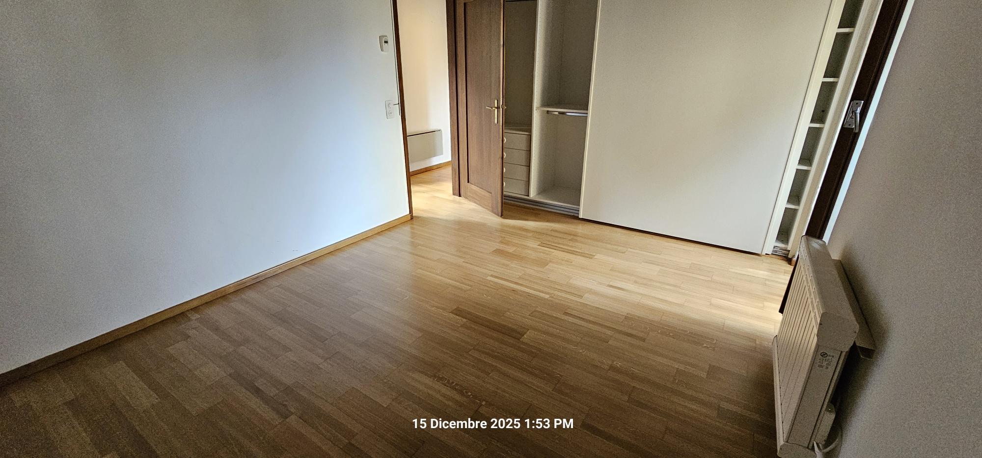 Leeres Zimmer mit Holzfußboden und Einbauschrank