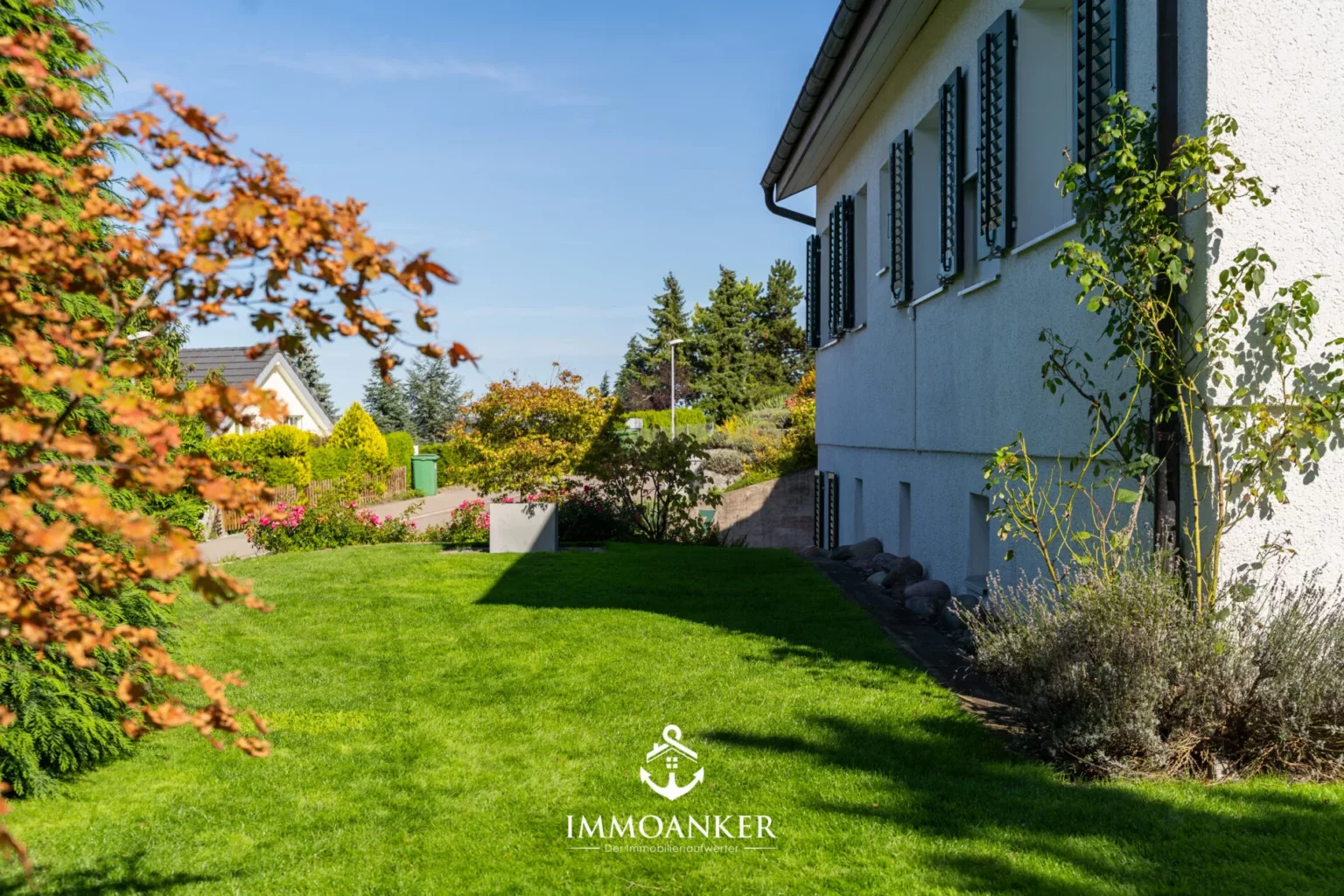 Gepflegter Gartenbereich neben einem Wohnhaus