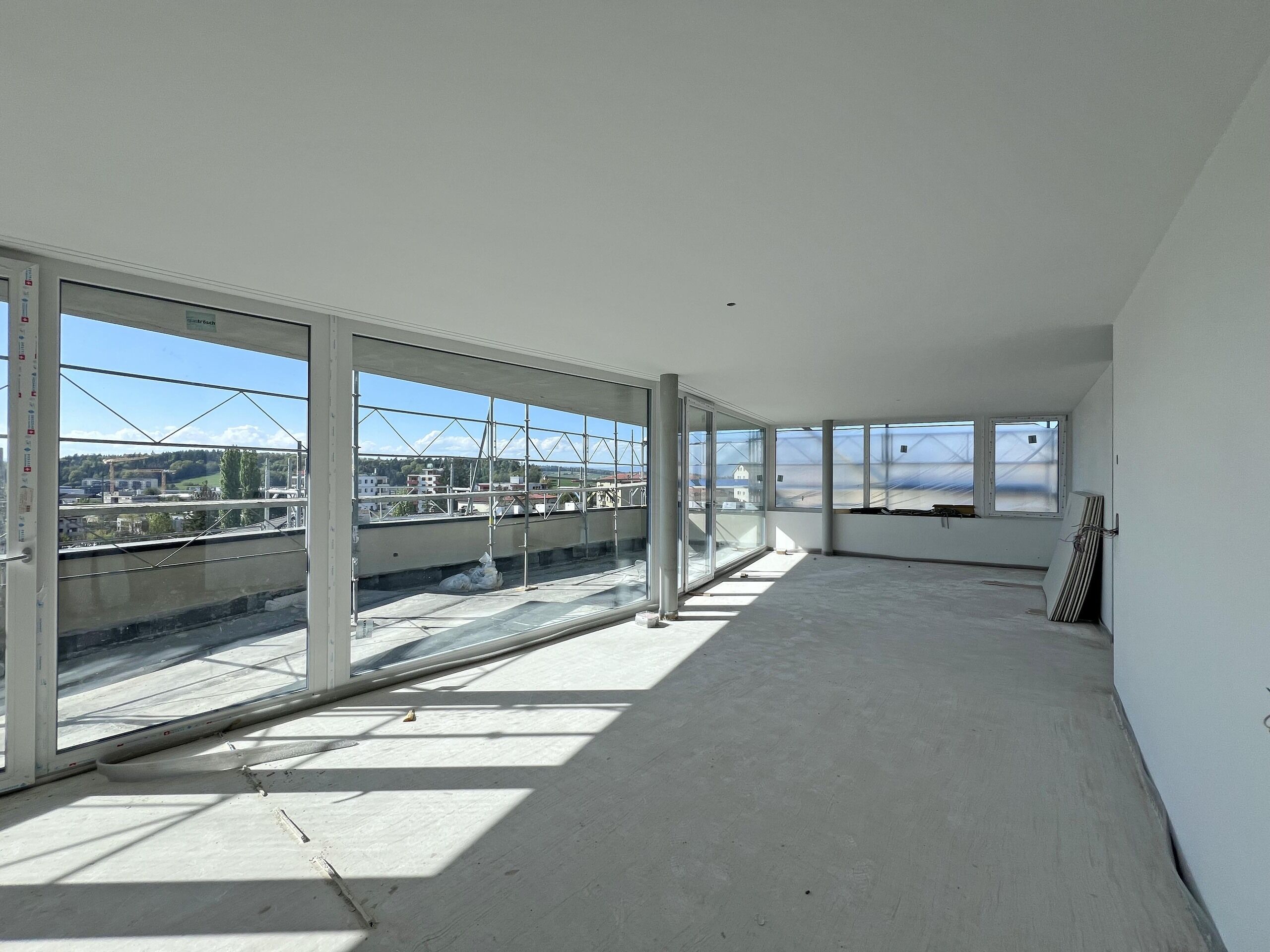 Großer leerer Neubau-Raum mit Panoramafenstern
