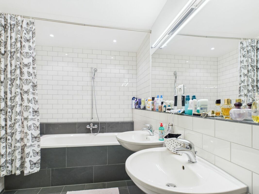 Modernes Badezimmer mit Wannenbereich und Doppelwaschbecken