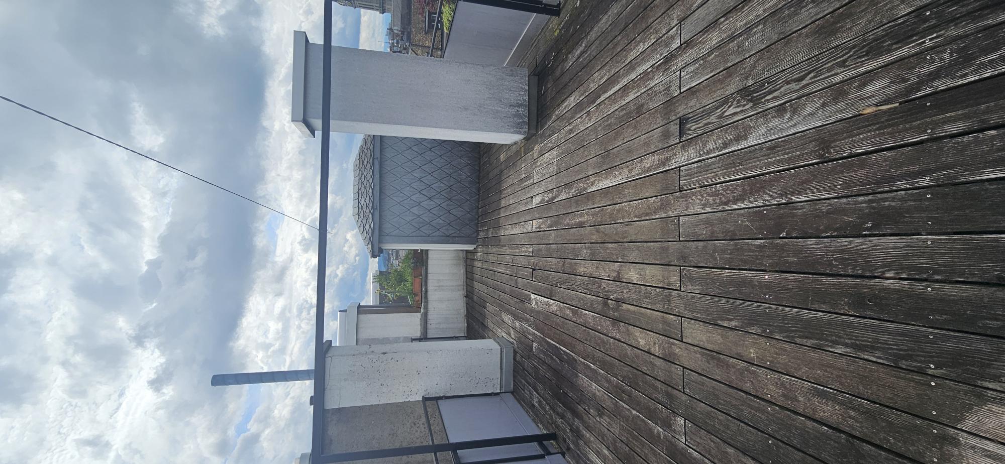 Dachterrasse mit Holzbelag und Stadtblick