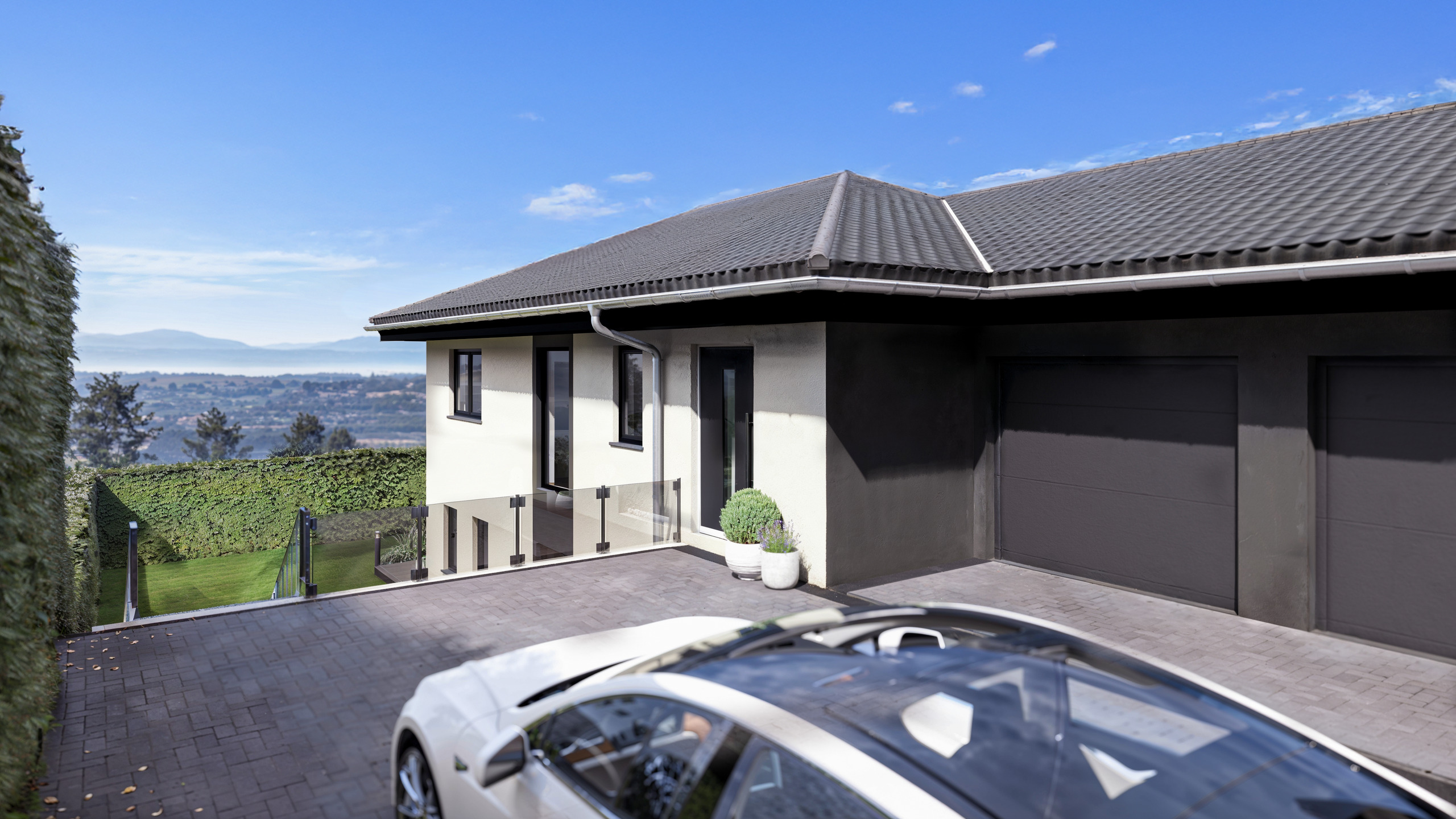 Moderne Einfahrt mit Doppelgarage und Fernblick