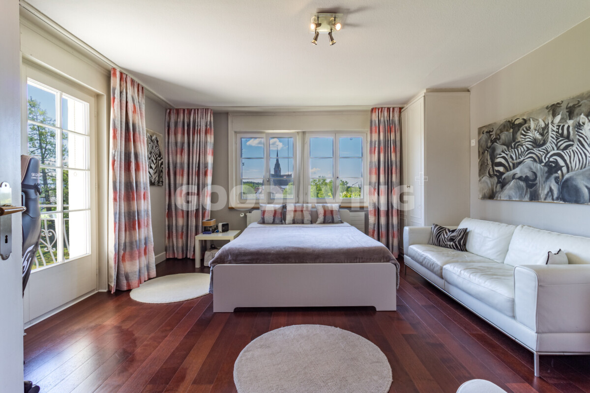 Helles Schlafzimmer mit Sitzbereich und Ausblick