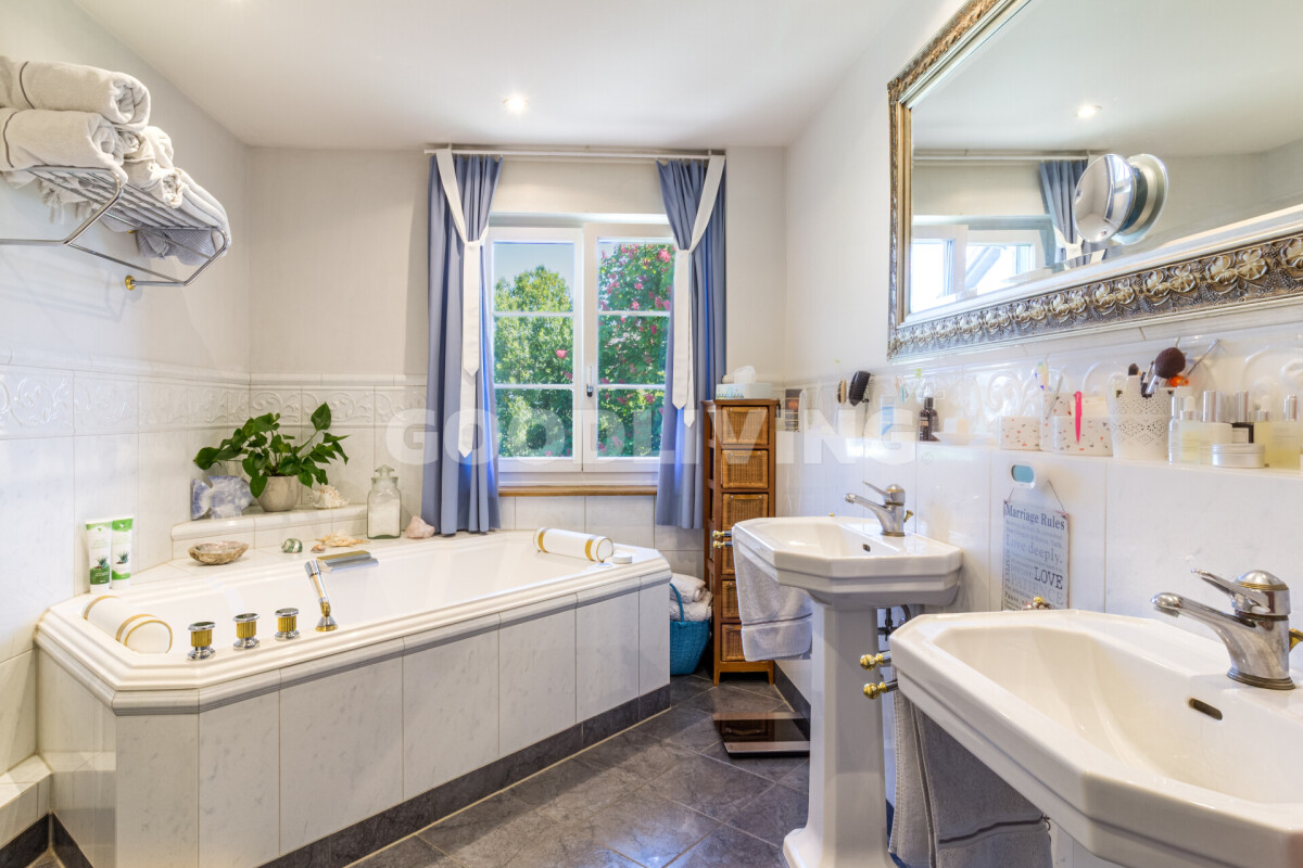 Badezimmer mit Doppelwaschbecken und Badewanne