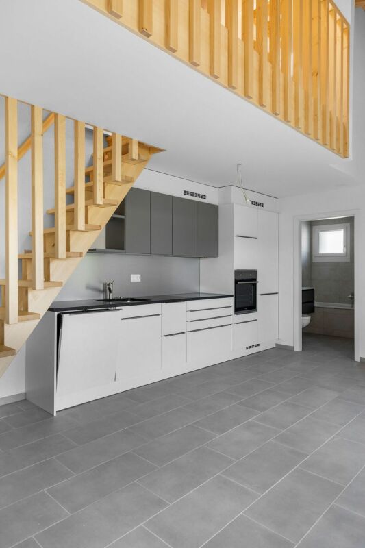 Offener Wohnbereich mit Küche und Treppe
