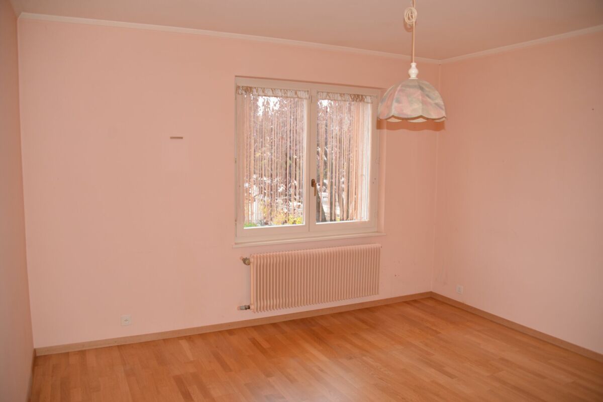Leerer heller Raum mit Fenster und Heizkörper
