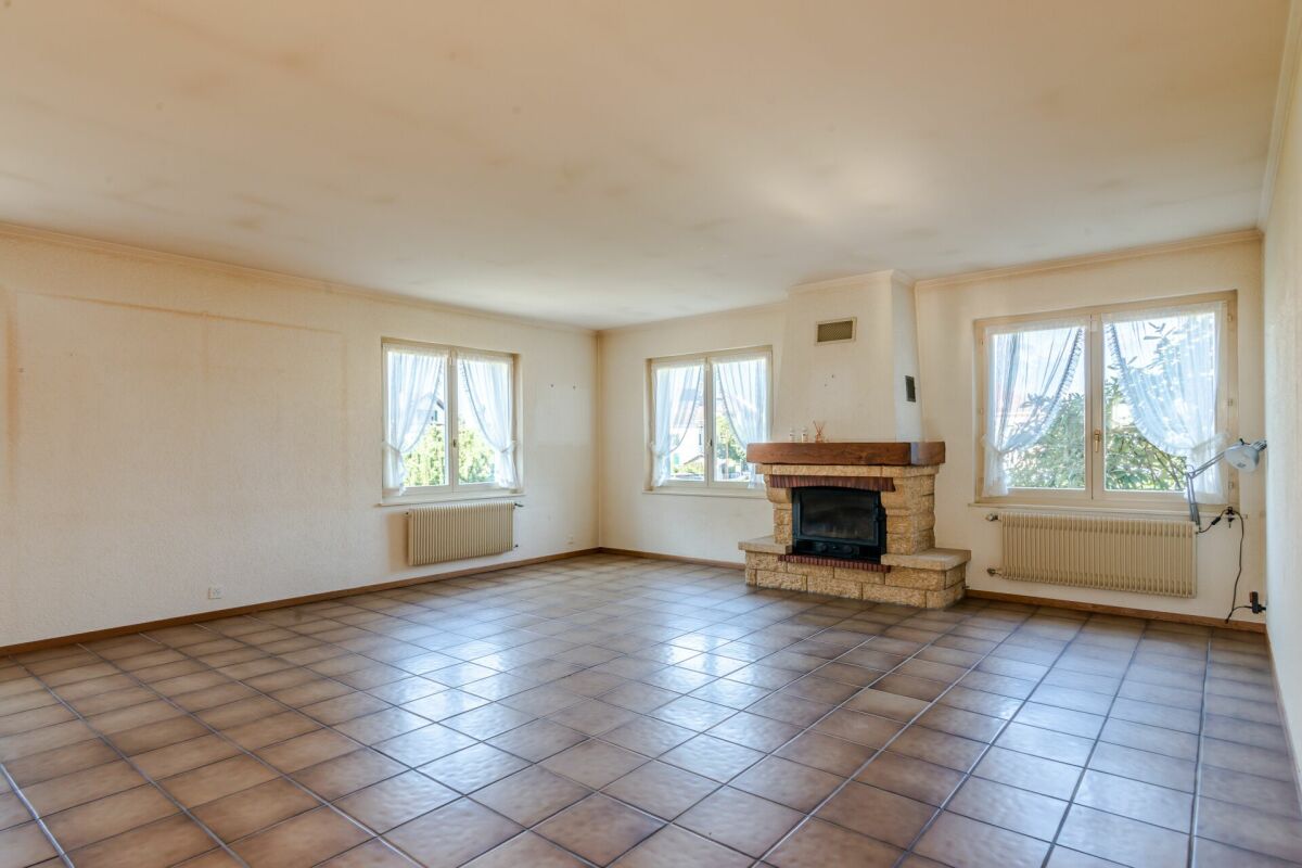 Wohnzimmer mit Kamin und Fliesenboden