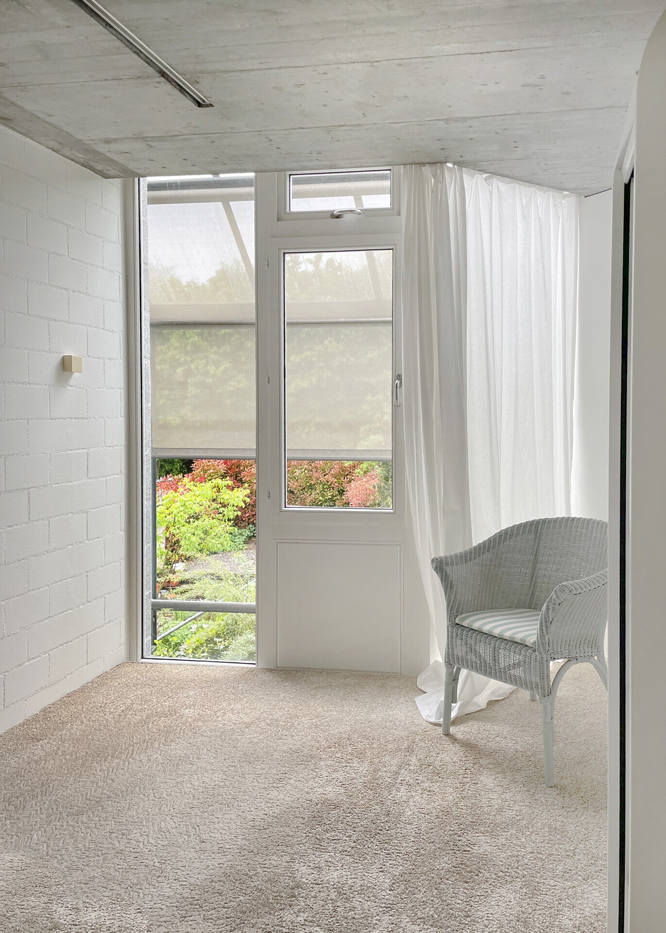 Heller, modern wirkender Raum mit großem Fenster