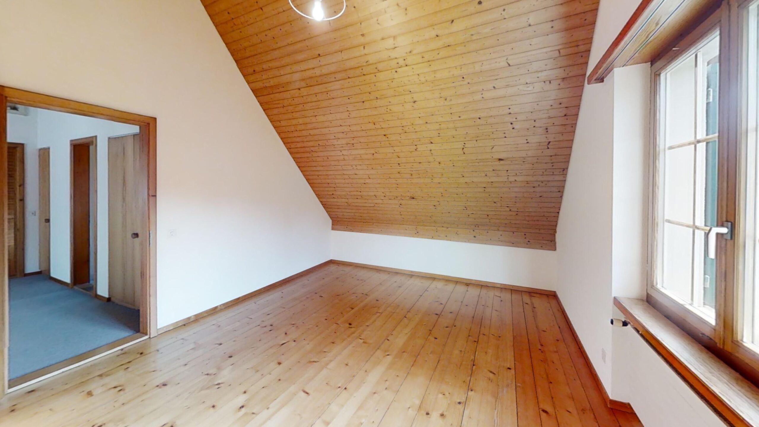 Leerer Dachraum mit Holzdecke und Holzboden