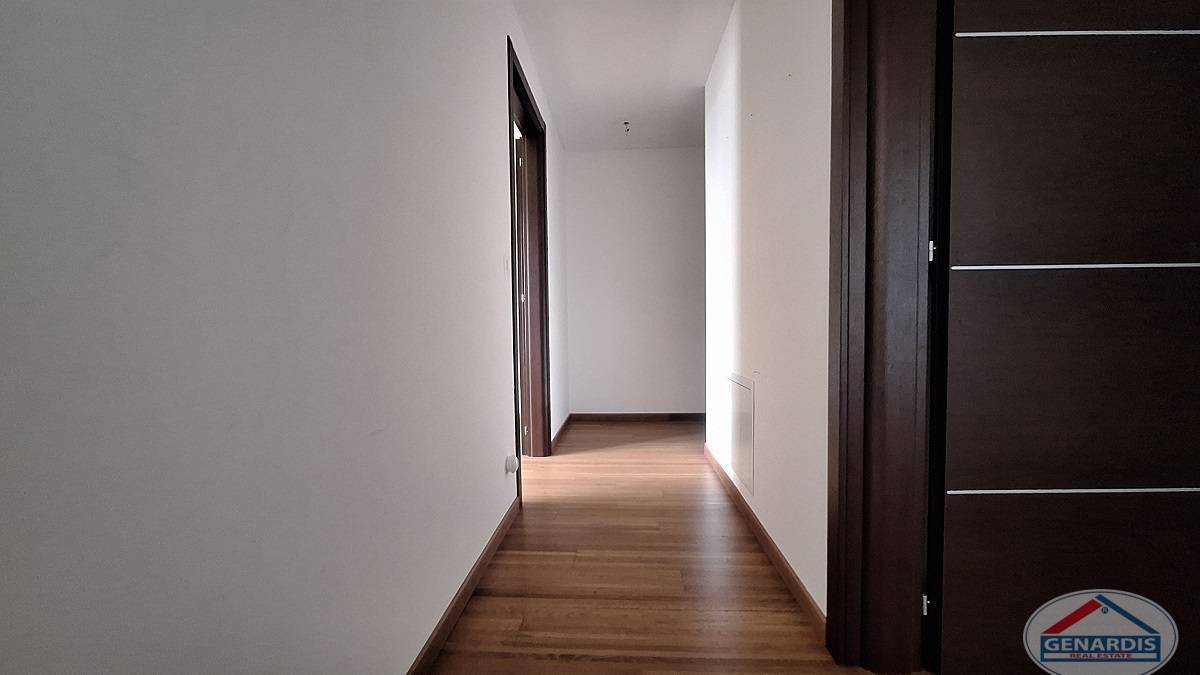 Flur mit Holzboden und dunklen Türen