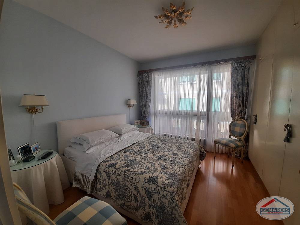 Helles Schlafzimmer mit großem Fenster und Einbauschrank