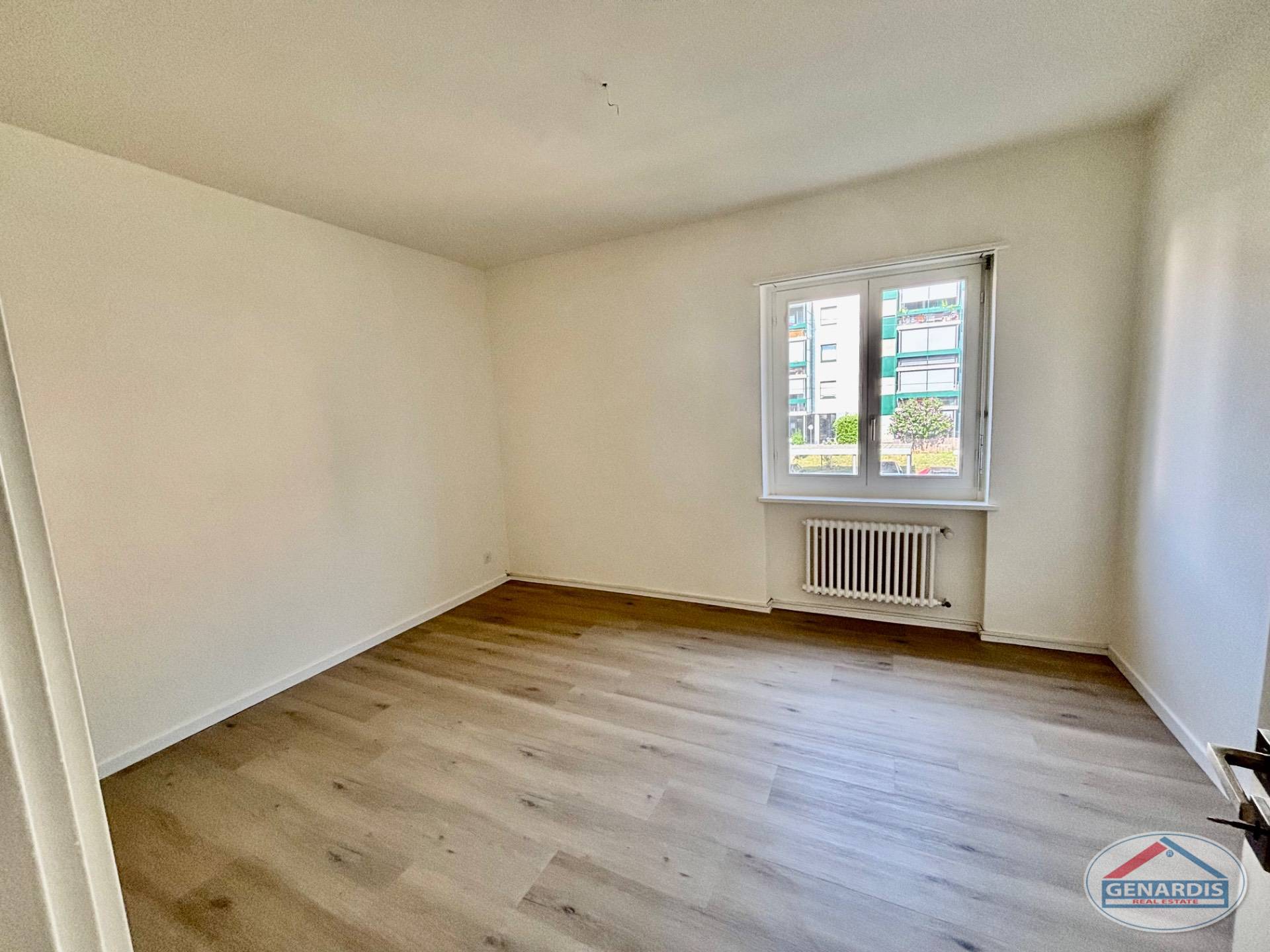 Leerer Wohnraum mit Fenster und Heizkörper