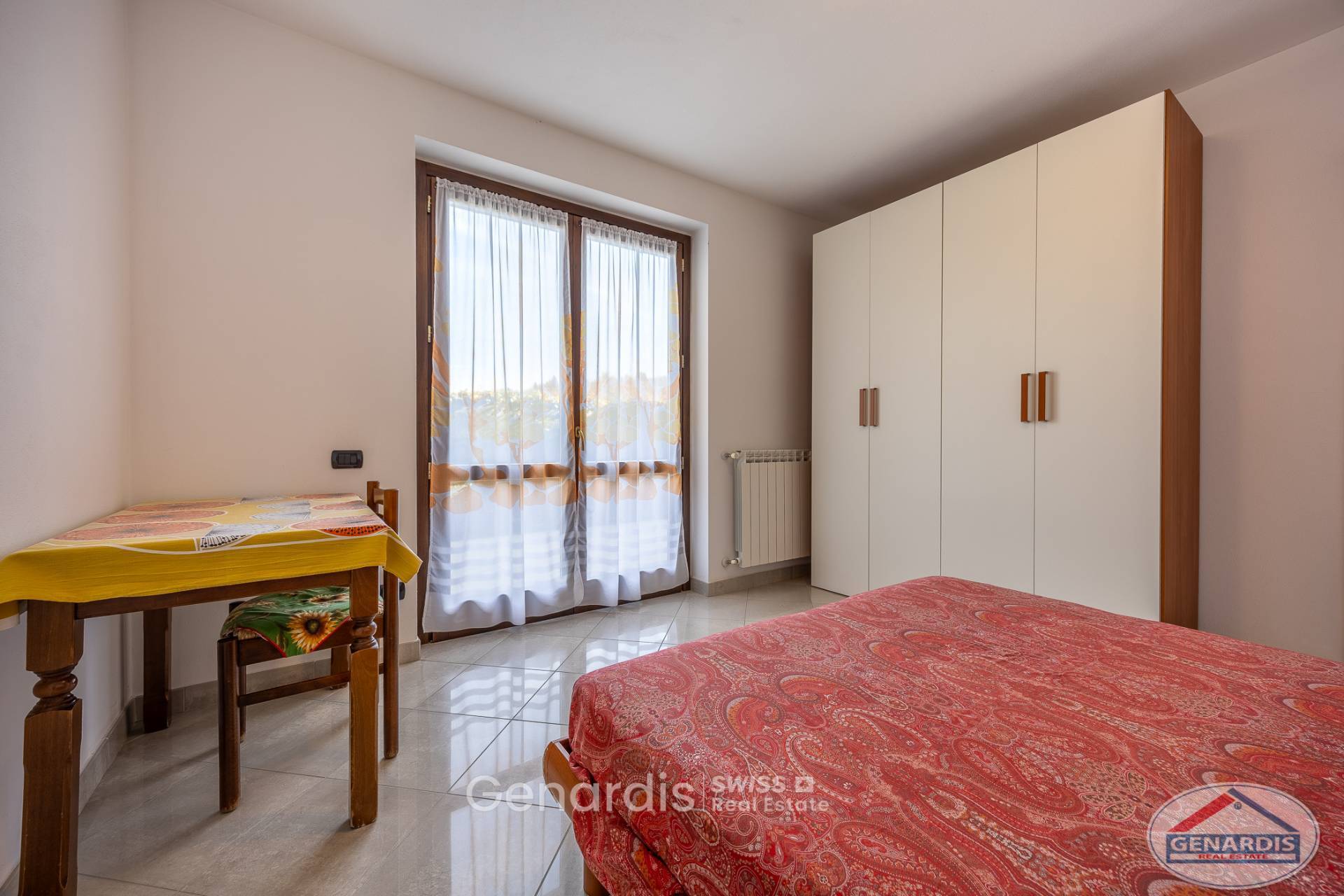 Helles Schlafzimmer mit Schrank und Fenster