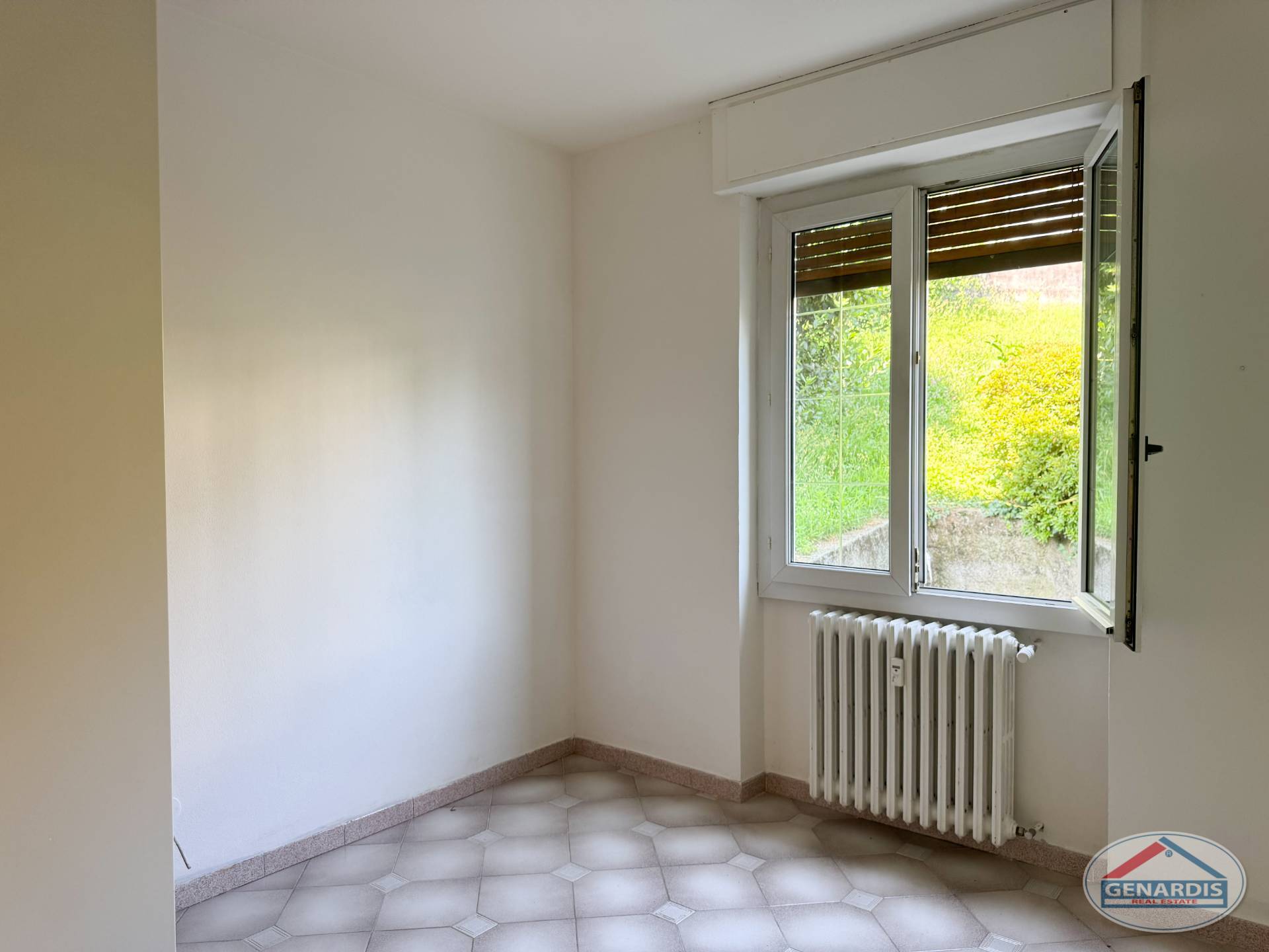 Leerer heller Raum mit Fenster und Heizkörper